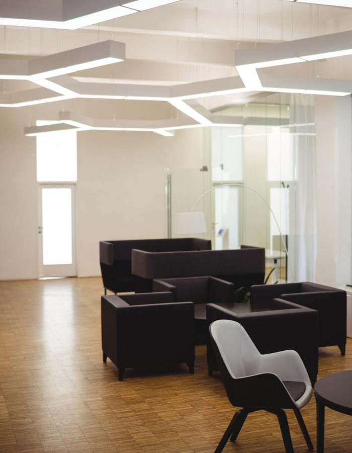 View of empty modern office with sofa, table, chair